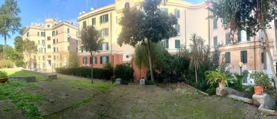 a large building with trees in front of it at Al lotto 27 Garbatella Storica in Rome