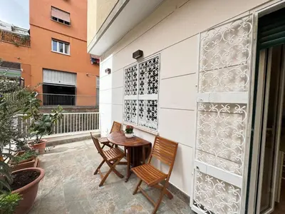 a patio with two chairs and a table at Cozy Place at Gianicolo in Rome