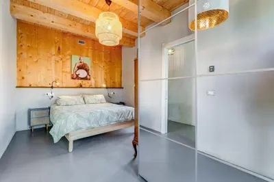 a bedroom with a bed and a wooden wall at Modern Rooftop Apartment in Rome