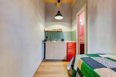 a kitchen with a bed and a sink in a room at garden studio apartment in Rome