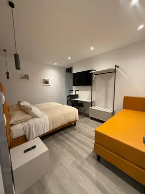 a bedroom with two beds and a desk in it at FoffoSuite in Rome