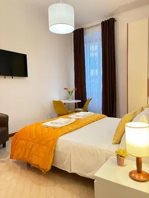 a bedroom with a large bed with a yellow blanket at Cortile di Testaccio in Rome