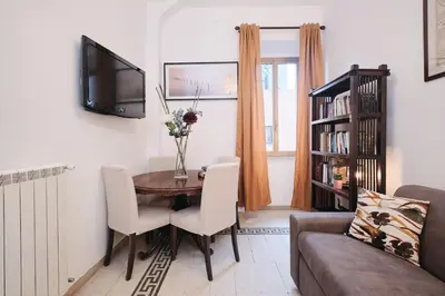 a living room with a table and a couch at NEW - La Casetta di Nadia in Rome