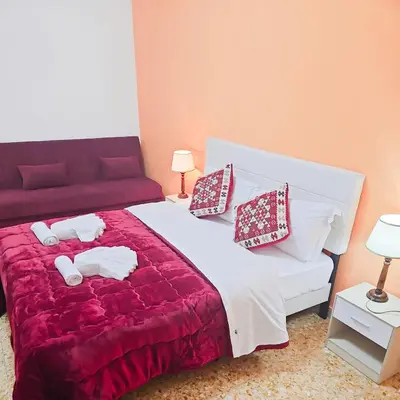 a bedroom with a bed and a red couch at NEXT Palace in Rome