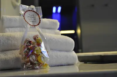 a pile of towels and a small bag of candy at Place 24 Suites & Wellness in Rome