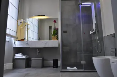 a bathroom with a shower and a sink at Place 24 Suites & Wellness in Rome