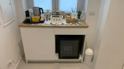 a kitchen with a counter top with a fireplace at Room A in Rome
