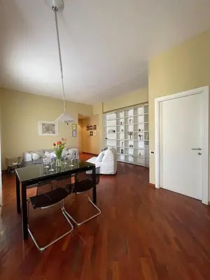 a living room with a table and a couch at San Giovanni Apartment Rome in Rome