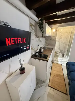 a kitchen with a netflix sign on a wall at Rome Nest at Campo De Fiori and Navona Square in Rome