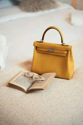 a bag and an open book next to a purse at Sweet Heaven Apartment in Rome
