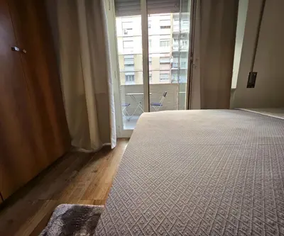 a bedroom with a bed and a large window at Simone House in Rome