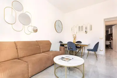 a living room with a couch and a table at Idyllia - Spacious bright flat in Rome