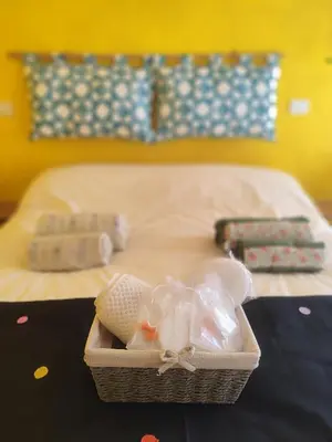 a basket sitting on a table in front of a bed at COLOSSEUM Studio Flat in Rome
