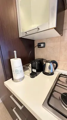 a kitchen counter with a stove and a toaster at Vatican YH in Rome