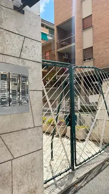two pictures of a gate in front of a building at Vatican YH in Rome
