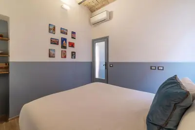 a bedroom with a bed and a window at Orti Apartment - Charme Holidays in Rome