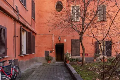 a orange building with a door and a tree at Orti Apartment - Charme Holidays in Rome