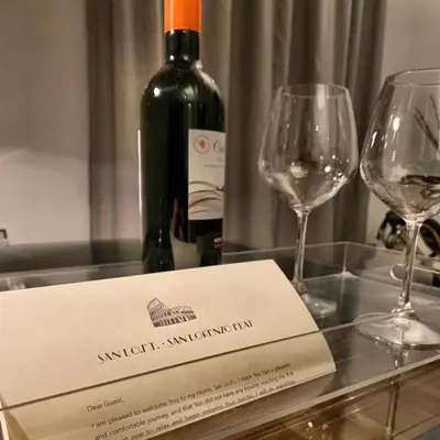a bottle of wine and two wine glasses on a table at San LoFt in Rome