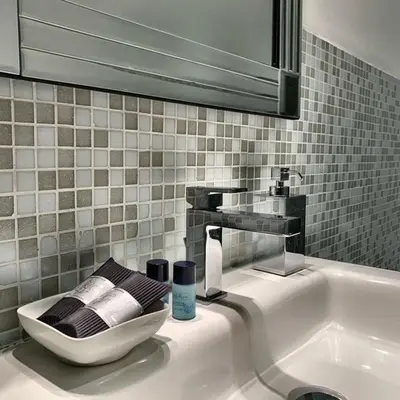 a bathroom sink with a faucet and a mirror at San LoFt in Rome