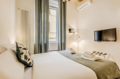 a bedroom with a white bed and a window at Bibi Home - Vaticano in Rome