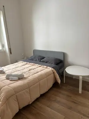 a bedroom with a large bed and a table at Casa da favola Roma in Rome