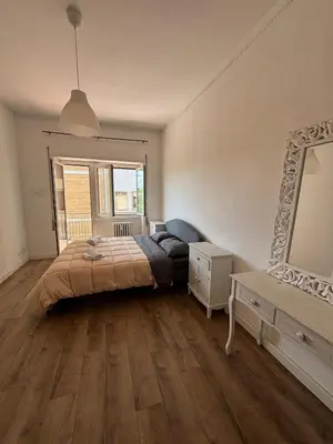 a bedroom with a large bed and a mirror at Casa da favola Roma in Rome