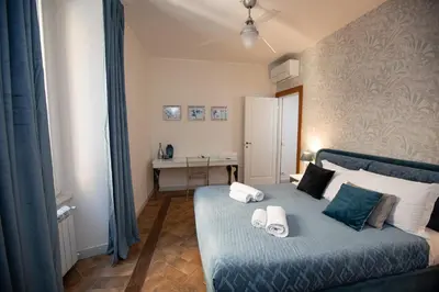 a bedroom with a blue bed with towels on it at Deluxe Spanish Steps in Rome