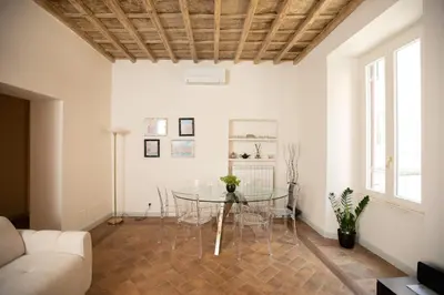 a living room with a glass table and a couch at Deluxe Spanish Steps in Rome