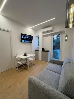 a living room with a couch and a table at Maryam Vatican Suites in Rome