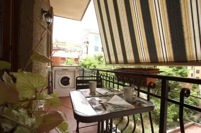 a balcony with a table and a washing machine at Margherita Holiday Home in Rome