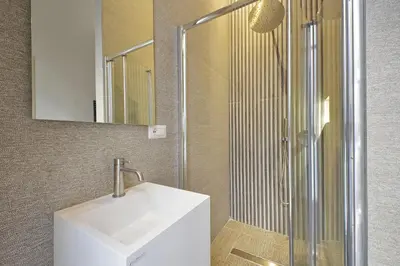 a bathroom with a white sink and a shower at Velvet Inn in Rome