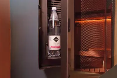 a bottle of wine is inside of a refrigerator at Velvet Inn in Rome