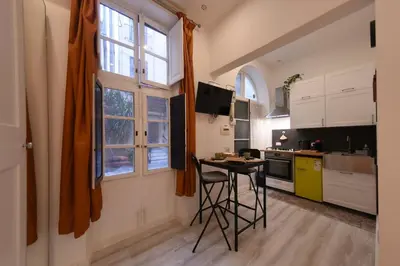 a kitchen with a table and a window at Appartamento San Lorenzo di Massimo & Luisa in Rome