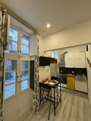 a kitchen with a table in the middle of a room at Appartamento San Lorenzo di Massimo & Luisa in Rome