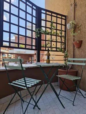 a table and two chairs in front of a window at Il Sogno Romano in Rome