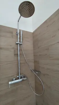 a shower with a shower head in a bathroom at 102 DreamHouse metropolitana B Libia in Rome