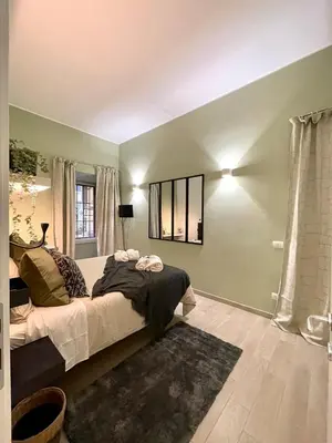 a bedroom with a bed and a mirror on the wall at Mazzini ApartmenT, next to Vatican City in Rome