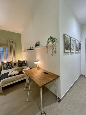 a bedroom with a bed and a wooden table at Mazzini ApartmenT, next to Vatican City in Rome