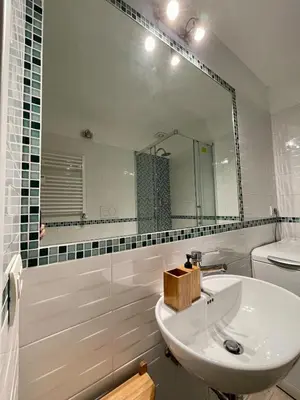 a bathroom with a sink and a mirror and a toilet at Mazzini ApartmenT, next to Vatican City in Rome