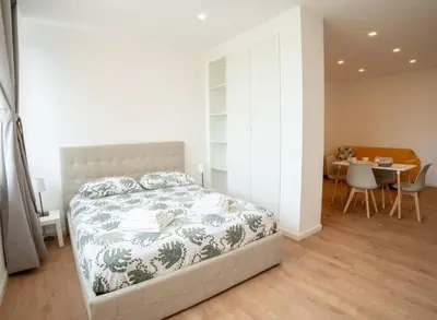 a bedroom with a bed and a table with chairs at Flaminia Garden Suite in Rome