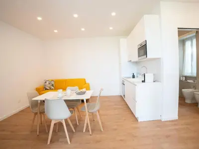 a kitchen and dining room with a table and chairs at Flaminia Garden Suite in Rome