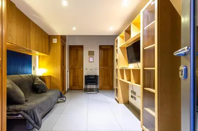 a living room with a couch and a tv in a room at Monti House - City Center in Rome