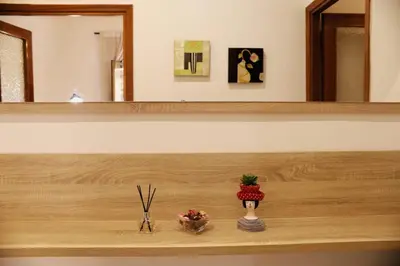 a wooden shelf with two vases and a mirror at A Casa di Rocco in Rome