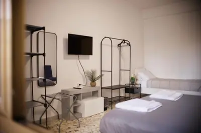 a living room with a bed and a couch at A Casa di Rocco in Rome