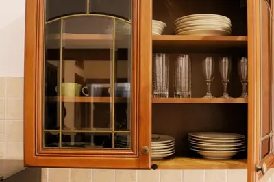 a wooden cabinet with plates and dishes in it at A Casa di Rocco in Rome