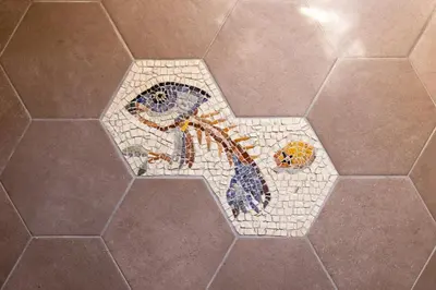 a mosaic star on a tile floor in a bathroom at Fascinating attic - up to 2 guests - Trastevere in Rome