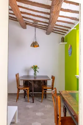a dining room with a wooden table and chairs at Fascinating attic - up to 2 guests - Trastevere in Rome