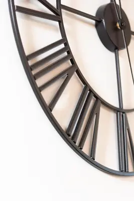 a black and white clock hanging on a wall at Thelma House - lovely apartment near Tiburtina Station in Rome