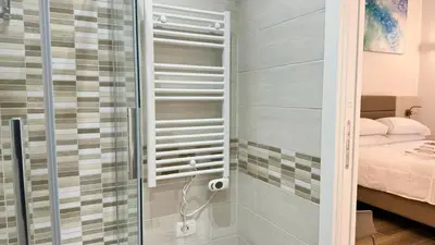 a shower with a glass door in a bedroom at Chich Suites in the Heart of Historic Rome in Rome