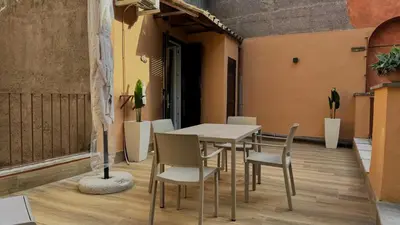 a table and chairs on the balcony of a building at Chich Suites in the Heart of Historic Rome in Rome